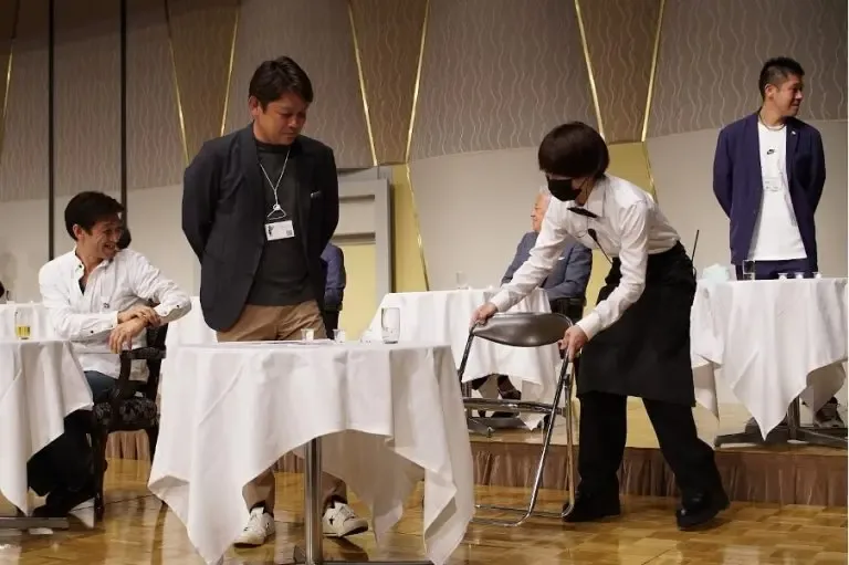格下げでパイプ椅子に移動する参加者